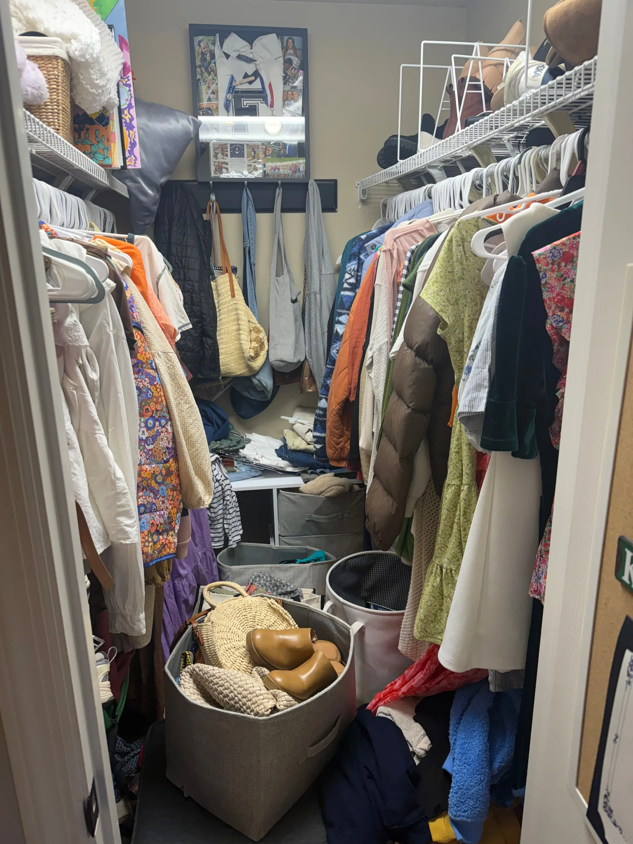 Walk-in closet with wire shelving and hanging rods on both sides.