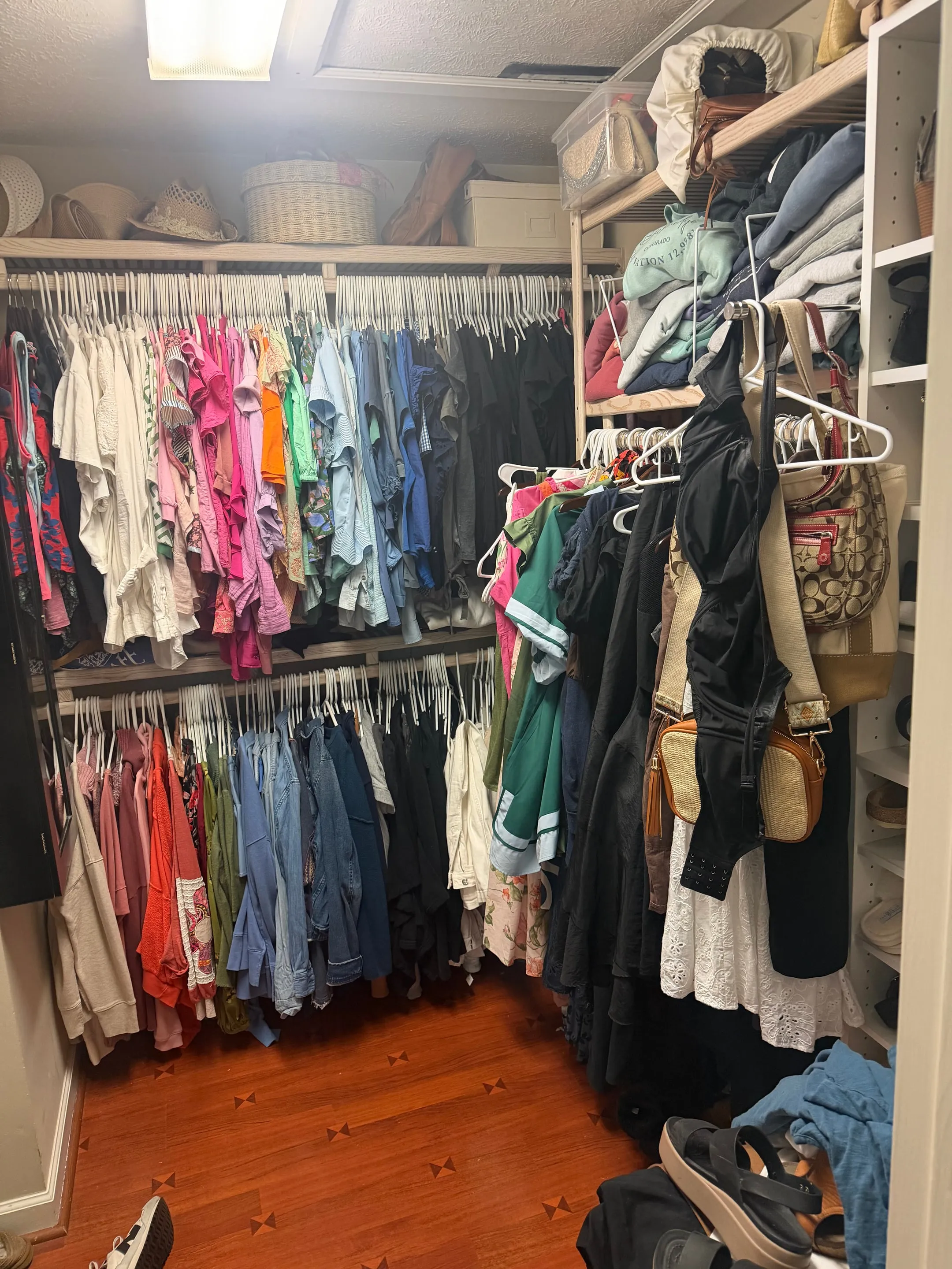 Walk-in closet with double hanging rods and shelving.